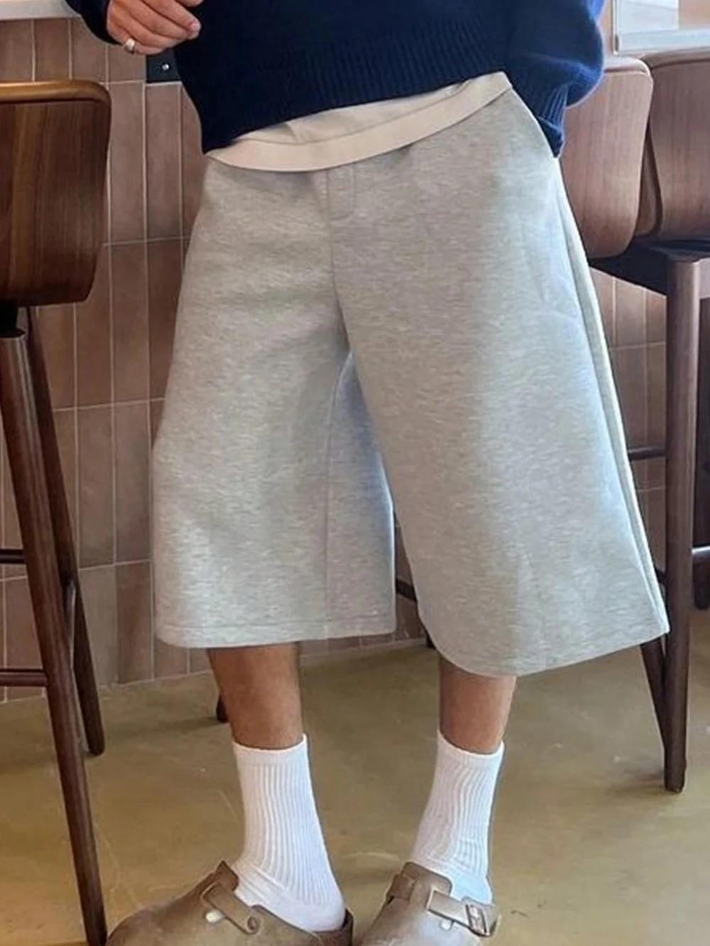 Shorts amples décontractés pour hommes, couleur unie, avec poches obliques, style estival élégant et