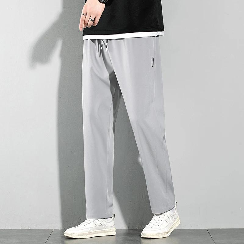 Pantalons pour hommes en soie glacée 2025 été nouveau noir gris mince pantalons décontractés d'affai